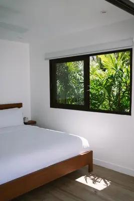 a bedroom with a bed and a window at Sky House Santa Teresa - Adults only in Santa Teresa Beach
