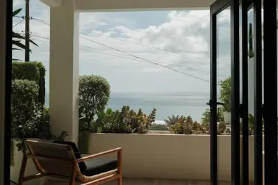 a view of the ocean from a porch with a chair at Sky House Santa Teresa - Adults only in Santa Teresa Beach