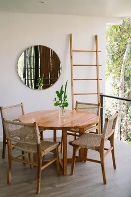 a wooden table with chairs and a mirror at Sky House Santa Teresa - Adults only in Santa Teresa Beach