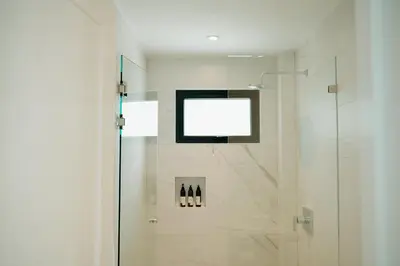 a bathroom with a shower with a glass door at Sky House Santa Teresa - Adults only in Santa Teresa Beach