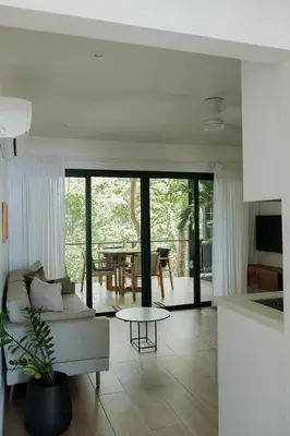 a living room with a couch and a table at Sky House Santa Teresa - Adults only in Santa Teresa Beach