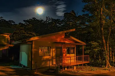 a small house at night with the moon behind it at Green Habitat in Monteverde Costa Rica