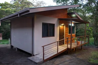 a small house with a porch and a deck at Green Habitat in Monteverde Costa Rica