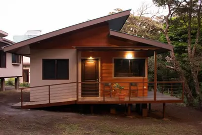 a tiny house on a deck with a porch at Green Habitat in Monteverde Costa Rica