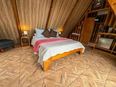 a bedroom with a bed and a tv in it at Tityra Lodge in Monteverde Costa Rica