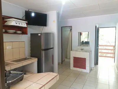 a kitchen with a stainless steel refrigerator and a sink at Centro Vacacional Bancosta in Jacó