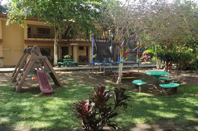 a park with a playground with a slide and a slideintend at Centro Vacacional Bancosta in Jacó