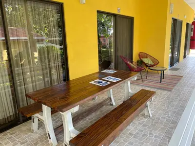 a wooden table and bench on a patio at Hotel LUZ de LUNA Bahía Ballena in Uvita