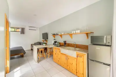 a kitchen with a sink and a refrigerator at Little Hawaii Avellanas in Playa Avellana