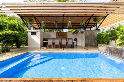 a pool with a pergola and a table and chairs at Little Hawaii Avellanas in Playa Avellana