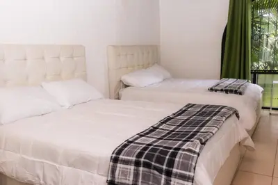 two beds sitting next to each other in a room at Hotel Casona del Valle in Potrerillos