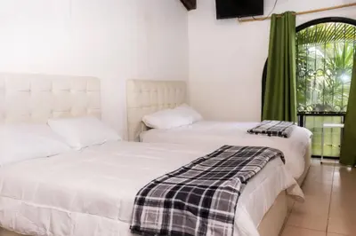 two beds sitting next to each other in a room at Hotel Casona del Valle in Potrerillos
