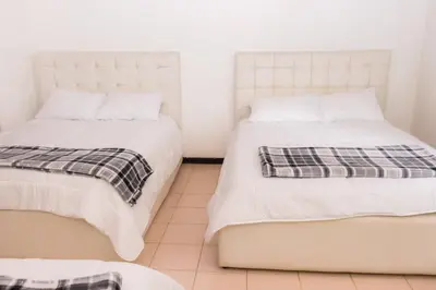 two beds sitting next to each other in a room at Hotel Casona del Valle in Potrerillos