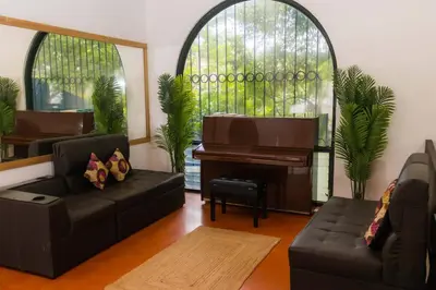 a living room with a piano and a couch at Hotel Casona del Valle in Potrerillos