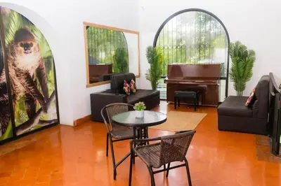 a living room with a table and a piano at Hotel Casona del Valle in Potrerillos