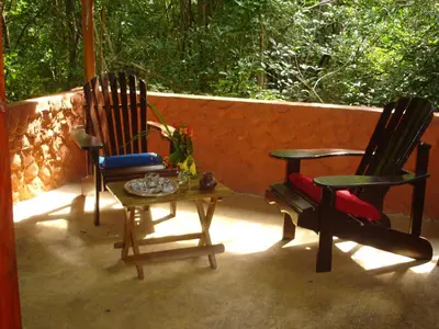 two chairs and a table on a patio at Mundo Milo Eco Lodge in Playa Junquillal