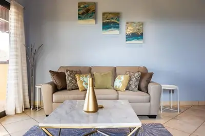 a living room with a couch and a table at Modern, Immaculate Unit in Flamingo with Spectacular Ocean Views in Playa Flamingo