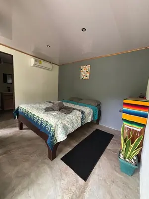 a small bedroom with a bed in a room at DS House in Cabuya