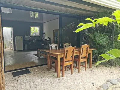 a wooden table and chairs in a living room at DS House in Cabuya