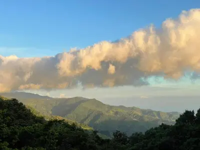 a view of the mountains with clouds in the sky at La Casa Bonita in Monteverde Costa Rica