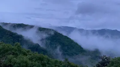 a view of a mountain covered in mist and clouds at La Casa Bonita in Monteverde Costa Rica