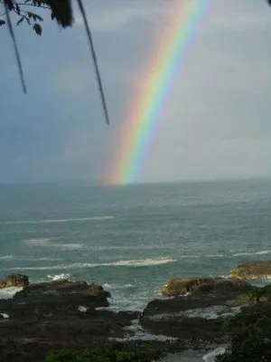a rainbow in the sky over a body of water at WINDOWS AT THE SEA in San Juanillo