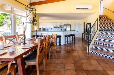 a dining room and kitchen with a table and chairs at Stunning Home with Brand-New Guesthouse and Oceanview Terrace with Private Swimming Pool & Hot Tub in Playa Flamingo