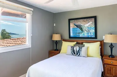 a bedroom with a bed and a window at Stunning Home with Brand-New Guesthouse and Oceanview Terrace with Private Swimming Pool & Hot Tub in Playa Flamingo