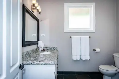 a bathroom with a sink and a mirror and a toilet at Stunning Home with Brand-New Guesthouse and Oceanview Terrace with Private Swimming Pool & Hot Tub in Playa Flamingo