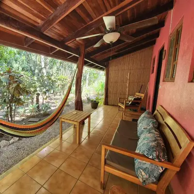 a living room with a hammock in a house at Villas Pura Vibra in Potrero