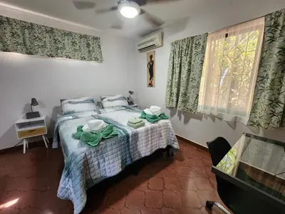 a bedroom with a bed and a window at Villas Pura Vibra in Potrero