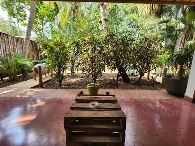 a wooden coffee table sitting on a brick patio at Villas Pura Vibra in Potrero