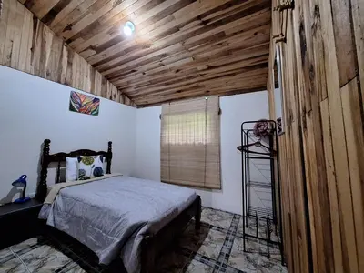 a bedroom with a bed and a wooden ceiling at Mountain view Monteverde, Cecropia Paradise in Monteverde Costa Rica