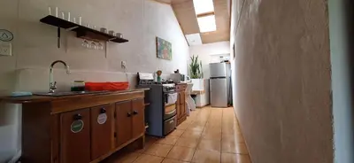 a kitchen with a sink and a stove and refrigerator at Mountain view Monteverde, Cecropia Paradise in Monteverde Costa Rica