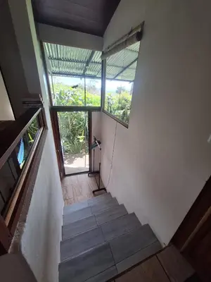 a staircase in a house with a window at Monteverde Cecropia Paradise in Monteverde Costa Rica