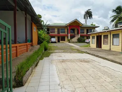 an empty driveway in front of a house at Hotel Heliconia Los Chiles in Los Chiles