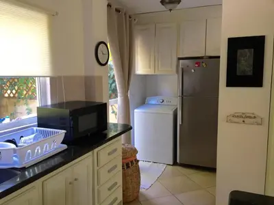 a kitchen with a refrigerator and a microwave at Montelaguna Boutique Hotel in Sámara