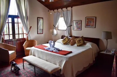 a bedroom with a bed with a blue ribbon on it at Cariari Bed & Breakfast in San José