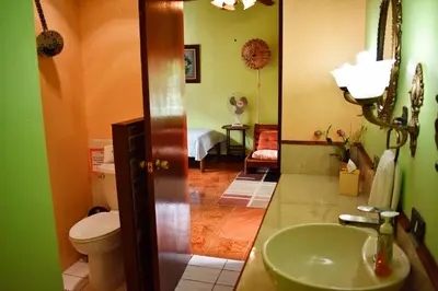 a bathroom with a sink and a toilet at Cariari Bed & Breakfast in San José
