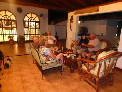 a group of people sitting in a living room at Cariari Bed & Breakfast in San José