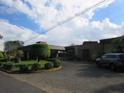a car parked in front of a building at Cariari Bed & Breakfast in San José