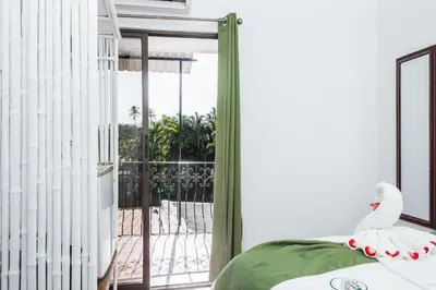 a bedroom with a bed and a sliding glass door at The Palms At Coco Beach in Coco