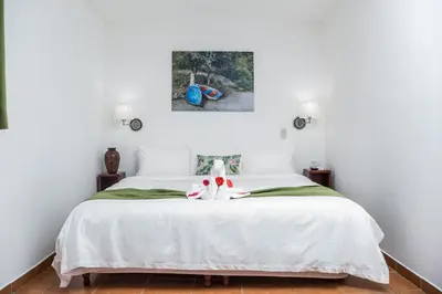 a bedroom with a white bed with two stuffed animals on it at The Palms At Coco Beach in Coco