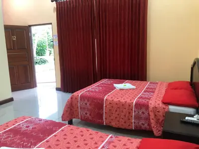 a room with two beds and a red blanket at Hospedaje Adrimaran in Palmares