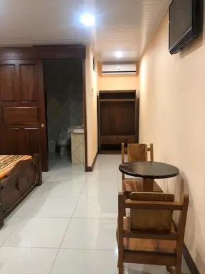 a dining room with a table and a bedroom at Hospedaje Adrimaran in Palmares