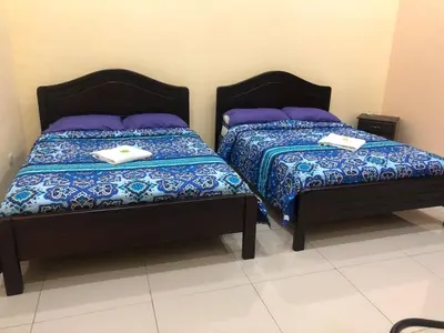 two beds sitting next to each other in a room at Hospedaje Adrimaran in Palmares