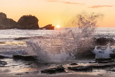 a person is splashing in the water at the beach at Tropical House in Nosara- 3 min walk to the beach in Río Seco