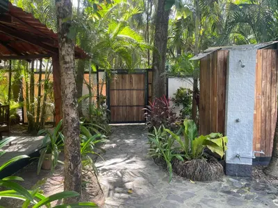 a garden with a wooden gate and a fence at Beach Villa S in Santa Teresa Beach