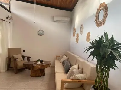 a living room with a couch and a table at Beach Villa S in Santa Teresa Beach