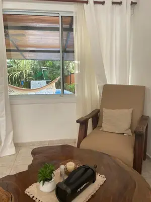 a room with a table and a chair and a phone at Beach Villa S in Santa Teresa Beach